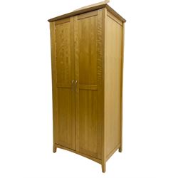 Contemporary beech double wardrobe, two panelled doors enclosing hanging rail