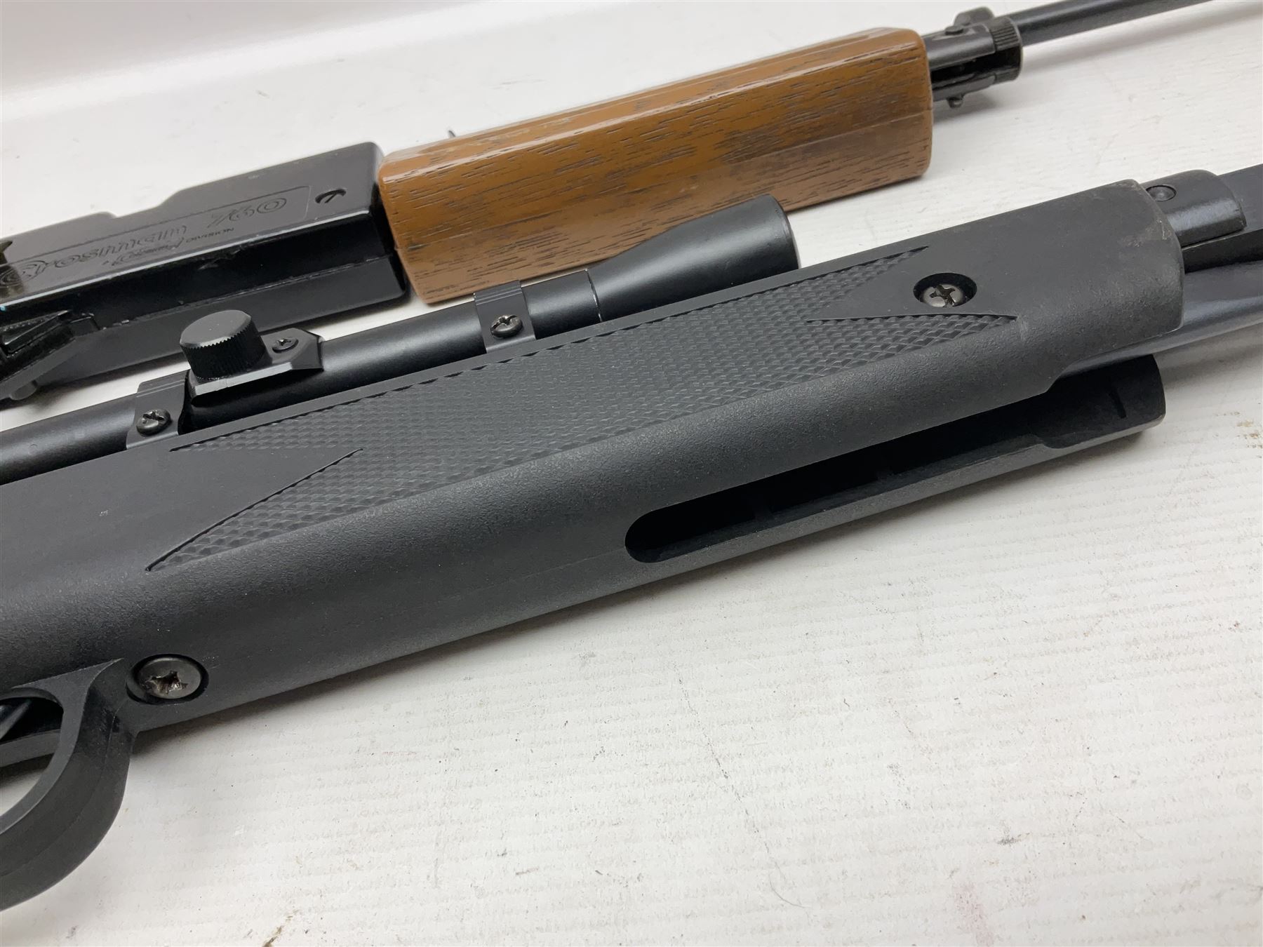 Crosman 760 .177 cal. Junior air rifle with under lever faux pump action and simulated wooden fittings; serial no.278047476, L90cm overall; and SMK B1 Synthetic .22 cal. Youth's air rifle with break-barrel action and 4 x 20 scope; serial no.1721229956084915F, L98.5cm overall (2)  NB: AGE RESTRICTIONS APPLY TO THE PURCHASE OF AIR WEAPONS.