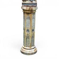 Farran stone garden statue depicting a hooded monk standing in flowing robes in circular form, set upon Gothic pedestal with arched panels, featuring lead hands and script band