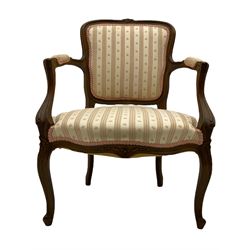 A pair of French walnut armchairs, upholstered in beige stripe fabric