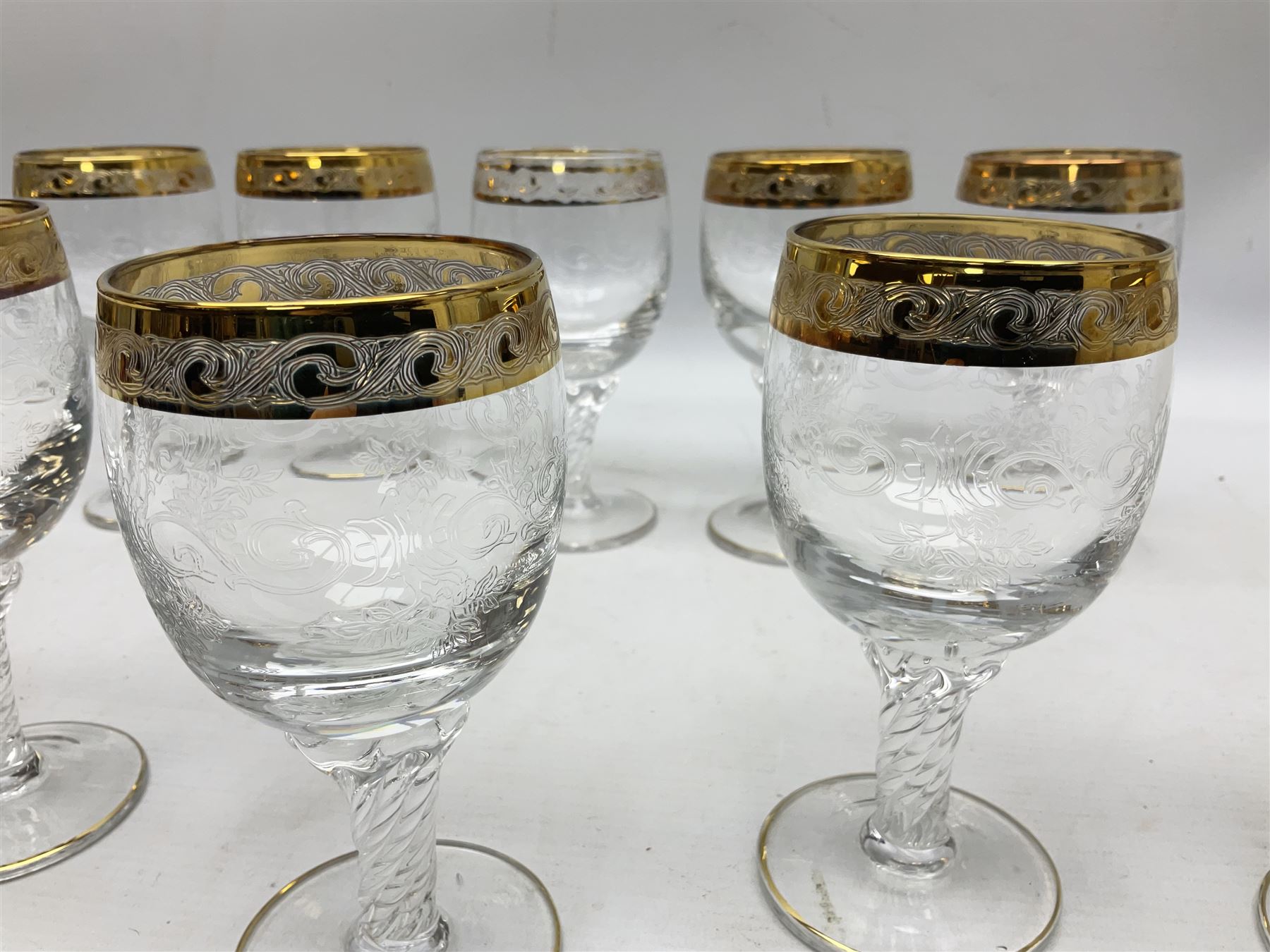 Set of twelve Moser style wine glasses, the bowls with etched floral bodies and gold banded rim with foliate decoration raised upon stem of twisted form, H14cm