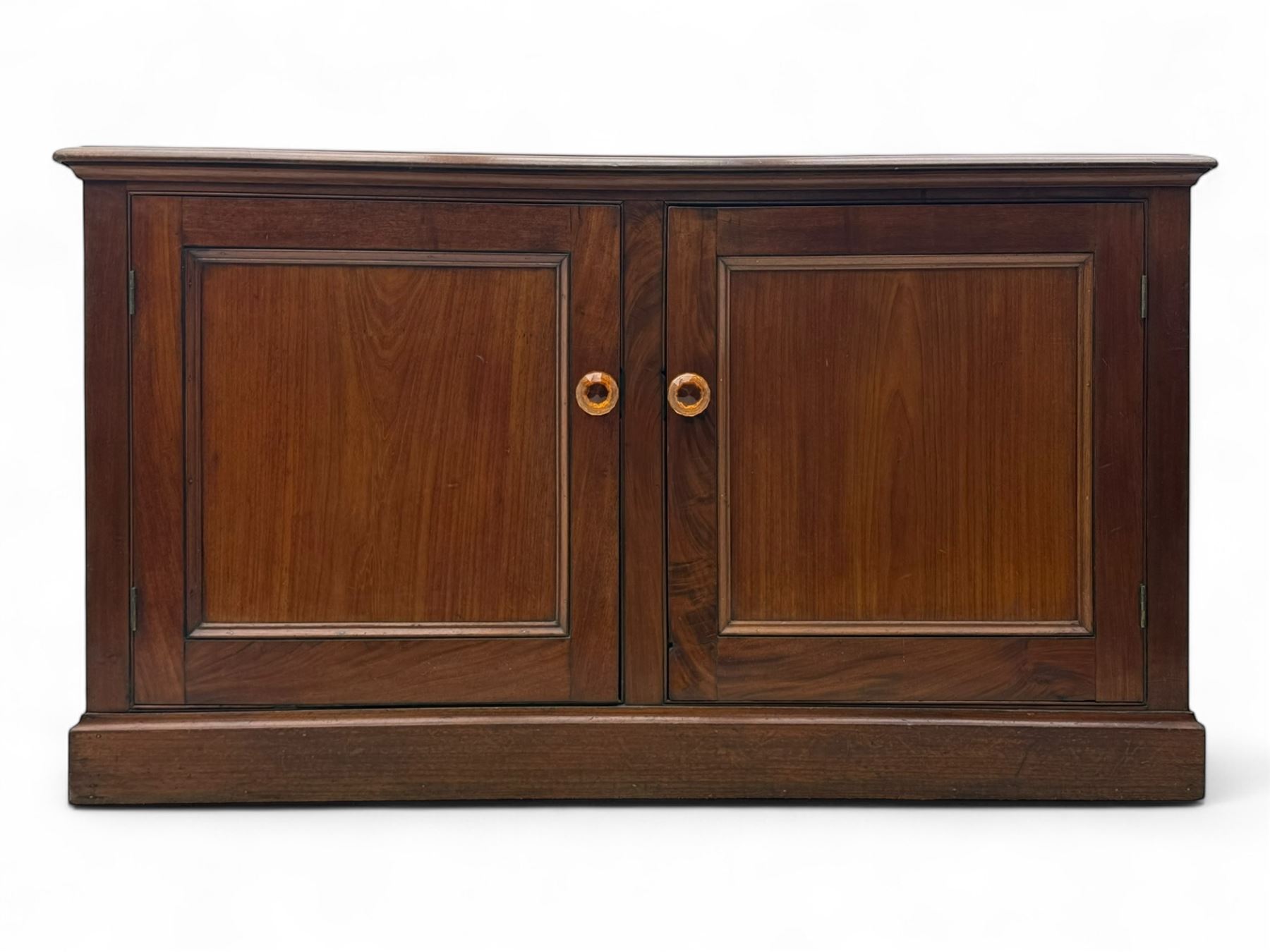 Victorian mahogany cupboard, plain rectangular top above two fielded panel doors opening to shelved interior, raised on a moulded plinth base, with later replacement knob handles