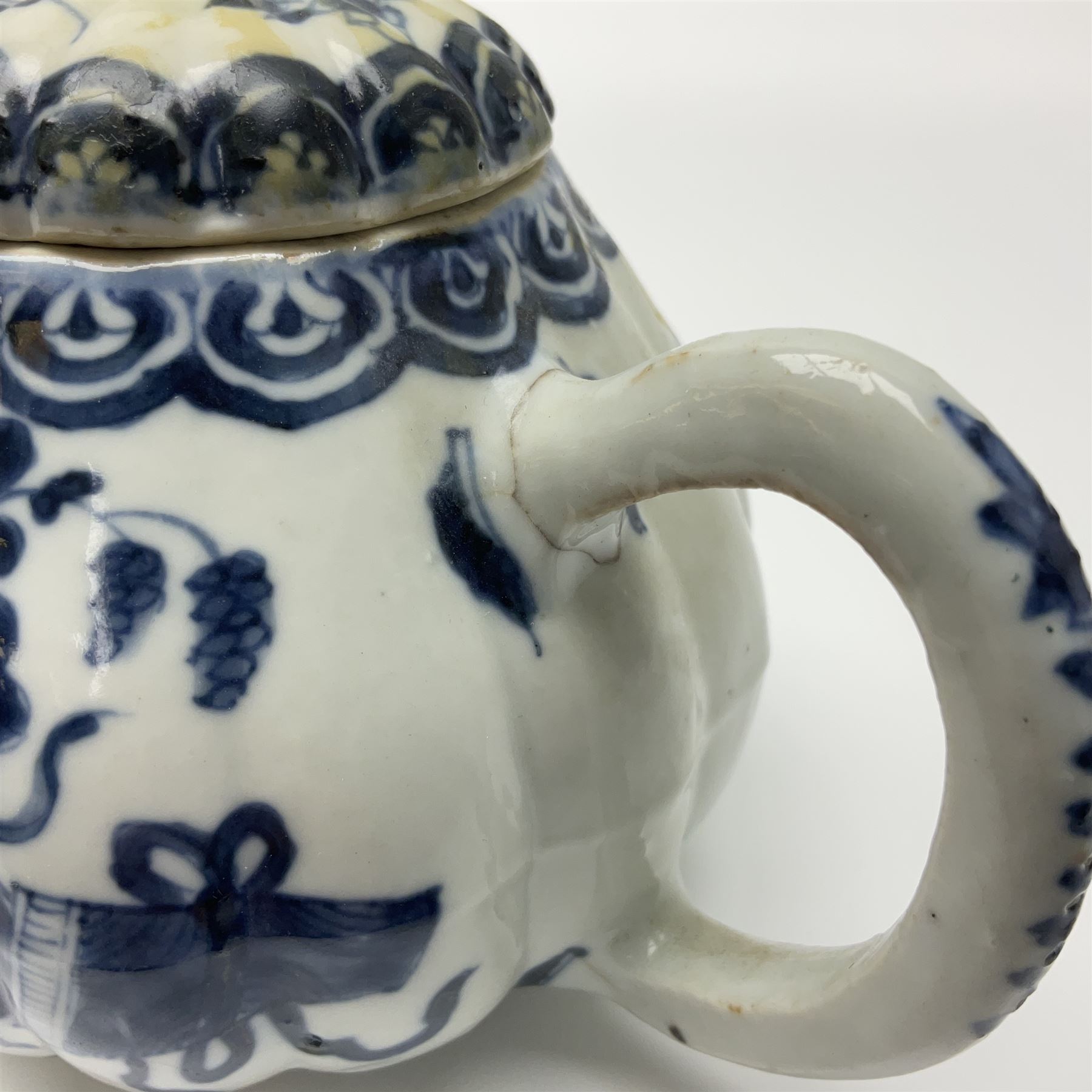 18th century Chinese blue and white teapot, painted with floral sprays, with lobed body and cover, H11cm