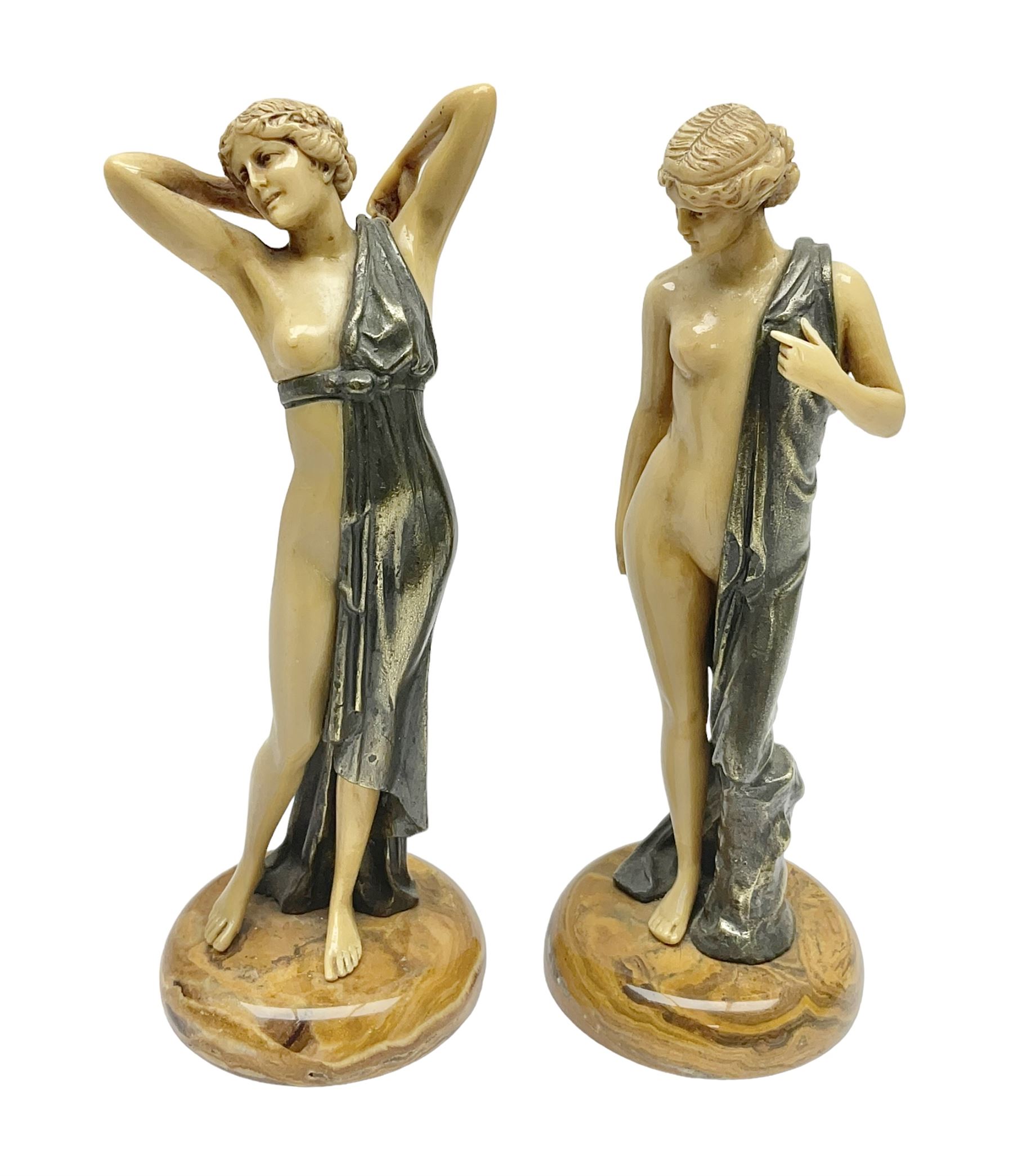 After Ferdinand Preiss (1882-1943), pair of Art Deco style, composite semi nude classical female figures, raised on circular onyx bases, H21cm