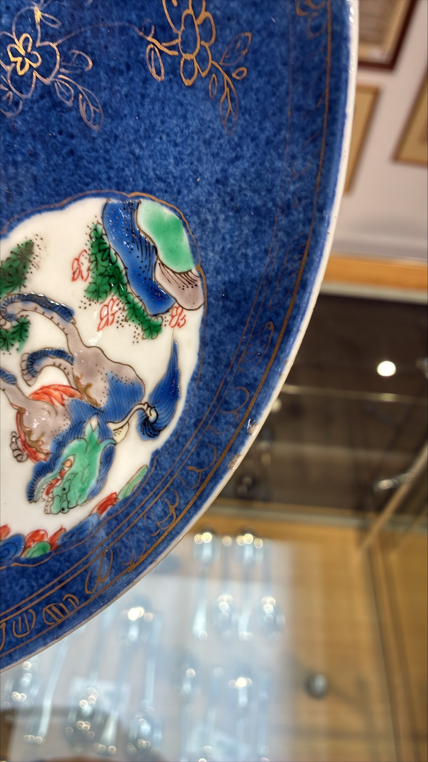 Chinese powder blue ground famille verte charger, possibly Kangxi, decorated with a central cartouche enclosing two female figures, with smaller shaped panels enclosing lions and foliage, square seal mark in blue to base, D28cm