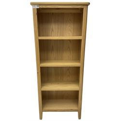 Contemporary light oak open bookcase, fitted with three shelves, on tapering supports