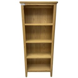 Contemporary light oak open bookcase, fitted with three shelves, on tapering supports