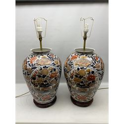 Pair of large and impressive 20th century Japanese Imari table lamps, each of ovoid form, decorated in the Imari palette with roundels containing flowering urns, and shaped panels of birds, set against a white ground decorated with blossoming peonies, lamp base (not including fixtures) H56.5cm overall including shade H89cm