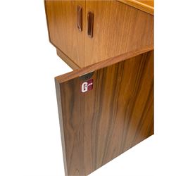 G-Plan - teak three-sectional wall display unit, fitted with raised display cabinet enclosed by two glazed doors, two double cupboards, bowed corner section fitted with shelves and cupboard