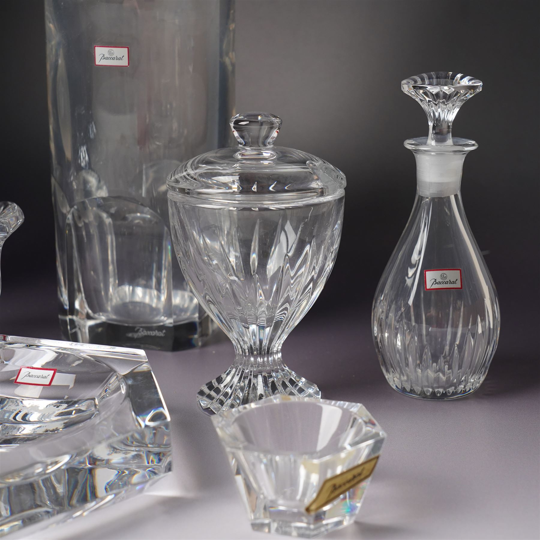 Collection of Baccarat Crystal, comprising a 'Pluton' decanter and two smaller examples, two covered condiment jars, pair of salt cellars, and an ashtray, variously boxed