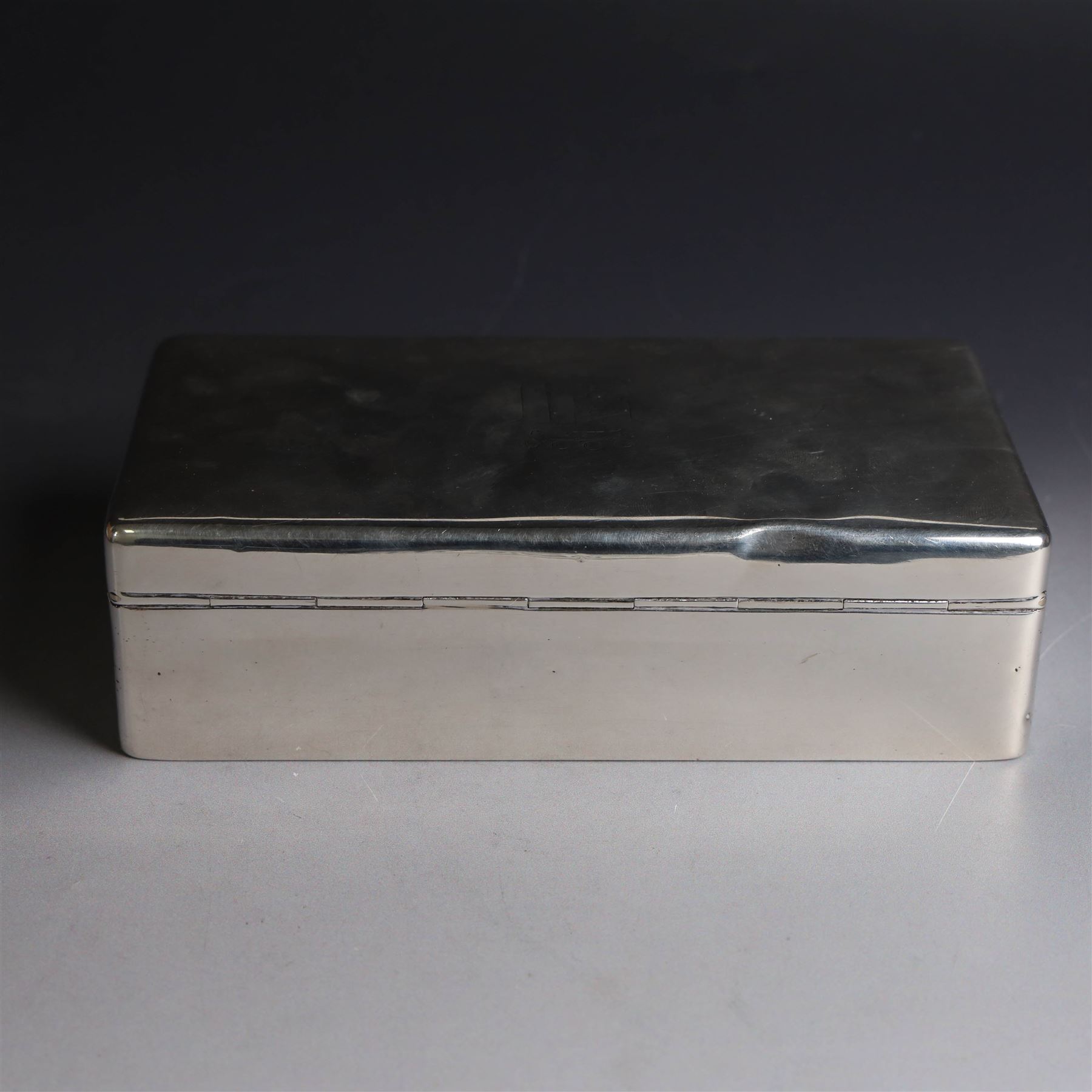 Mid 20th century silver mounted cigarette box, of rectangular form, with personal engraving to body reading 'Baron and Baroness Di San Marciano to Alan VG Bibby in grateful appreciation Malta April 1948, engraved with San Marciano family coat of arms to hinged cover, opening to reveal a softwood lined interior, hallmarked Adie Brothers Ltd, Birmingham 1946, H5cm, W16.5cm
