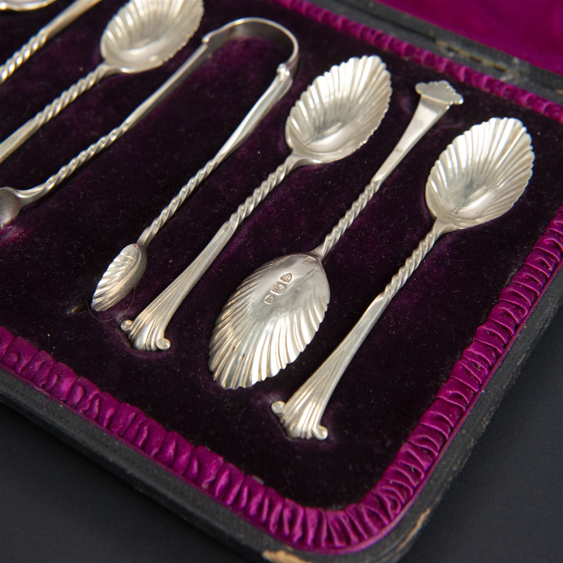 Set of six late Vitorian silver spoons and sugar tongs, each with twist and scroll handles and fluted bowls, hallmarked 	Josiah Williams & Co, London 1894, contained within fitted case