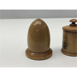 Six sewing related Mauchline ware comprising an oval reel box with internal label for Clark & Co's, tape measure, pin case and three thimble holders of ovoid form 