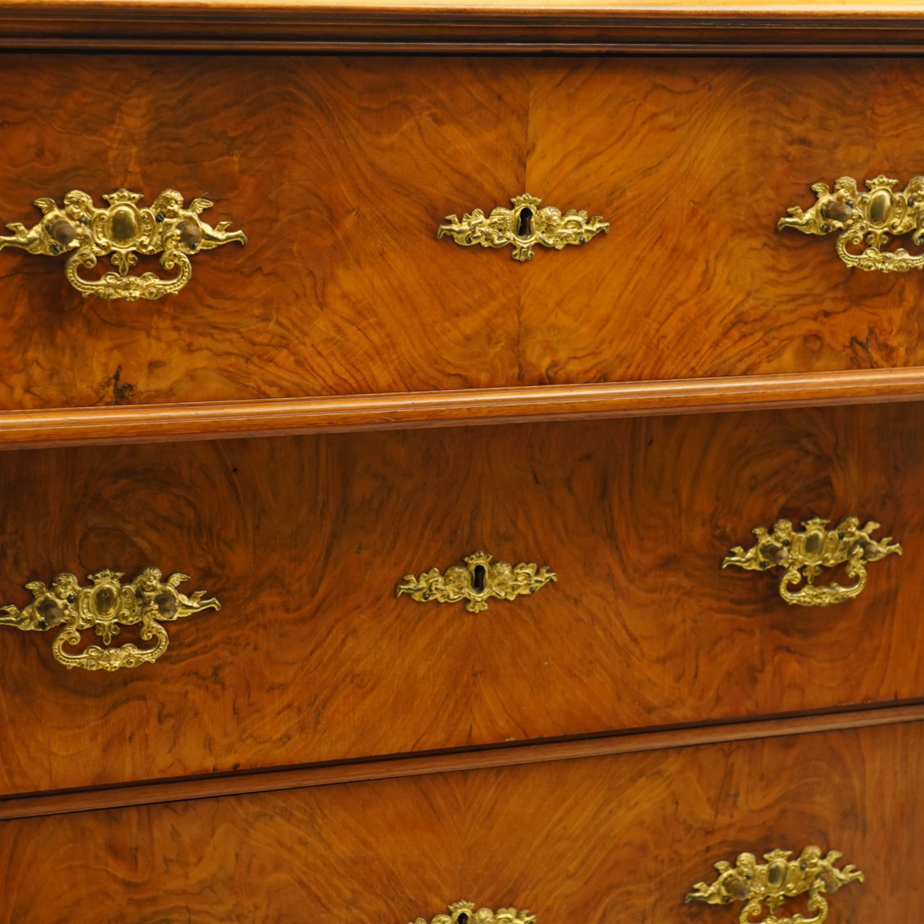 Tall late 19th century walnut chest, stepped and moulded top over six drawers, ornate cast gilt metal handles, enclosed by turned and fluted upright columns, on turned front feet 