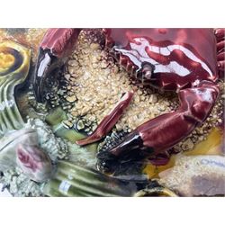 Five 20th Century Portuguese Palissy style Majolica wall plates, all depicting crustaceans to the centre modelled in relief surrounded by encrustations and shells, both with impress marks beneath, largest D29cm