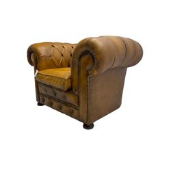 Chesterfield armchair, upholstered in buttoned tan leather with studded detail, on turned feet