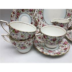 Windsor tea service for six decorated with blooming pink roses and purple flowers amongst foliage