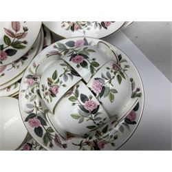 Wedgwood Hathaway Rose pattern tea and dinner wares, comprising twelve saucers, sixteen teacups, twenty tea plates, jug, sucrier, thirteen shallow bowls, sauce boat and saucer, two lidded tureens, larger jug, ten dinner plates, nine smaller plates and two large oval serving dishes