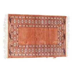 Small Afghan rust ground rug, plain field enclosed by patterned borders (94cm x 64cm); small Persian Hamadan indigo ground rug, decorated all-over with small flower head and bird motifs (118cm x 66cm); and a small Persian red ground rug (94cm x 62cm) (3)