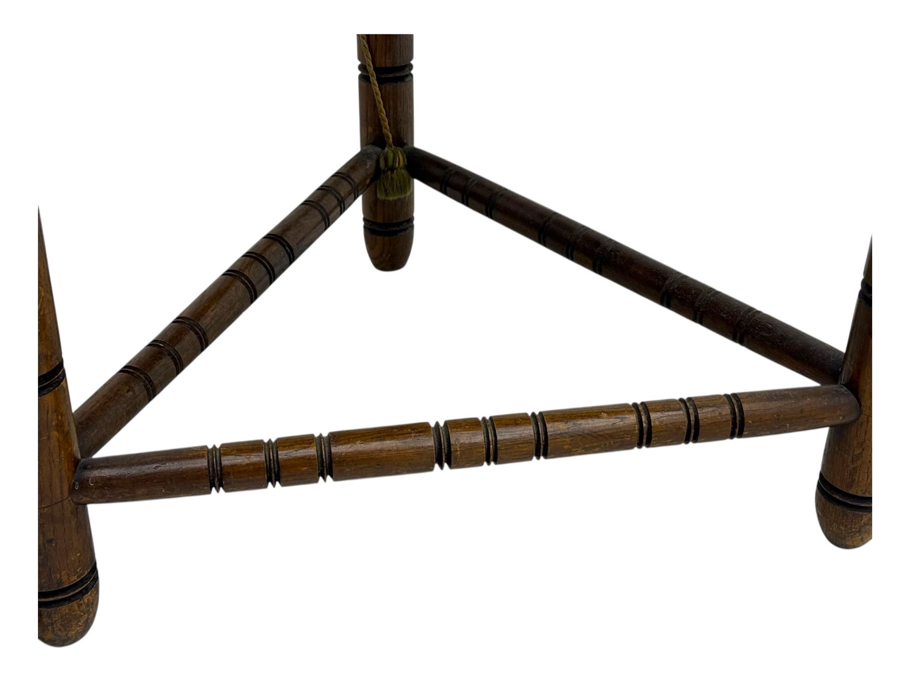 19th century swedish monk's chair, the oak frame with triangular seat and sloped arms, the backrest carved with geometric chipwork and a central pierced medallion 