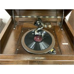 Early 20th century ‘HMV' 202 cabinet gramophone, oak cased, moulded top with foliate carved moulding hinges to reveal gramophone, two doors enclosing horn, on turned supports joined by moulded stretcher rails