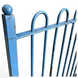 Two sections of painted iron garden or estate boundary railing, comprising a 19th century wrought iron section with graduated spearhead uprights, together with a later hoop-top section with ball-finial end posts, both in blue painted finish