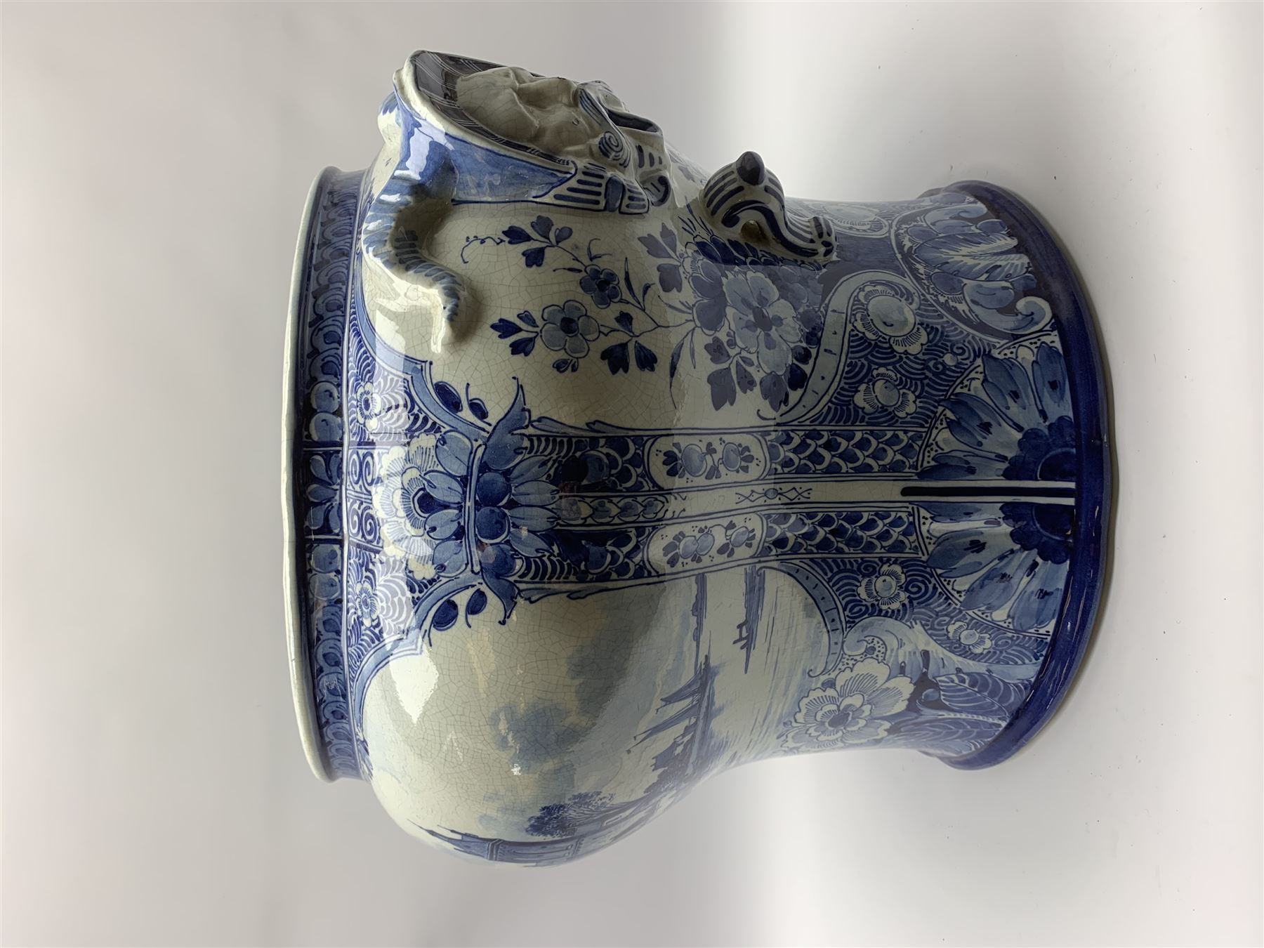 Large 20th century Delft blue and white jardinière, of baluster form with twin zoomorphic mask lug handles, decorated with hand painted panels of waterside scenes, within foliate surround, impressed and painted marks beneath for De Porceleyne Fles workshop, Delft, H35cm, rim D32