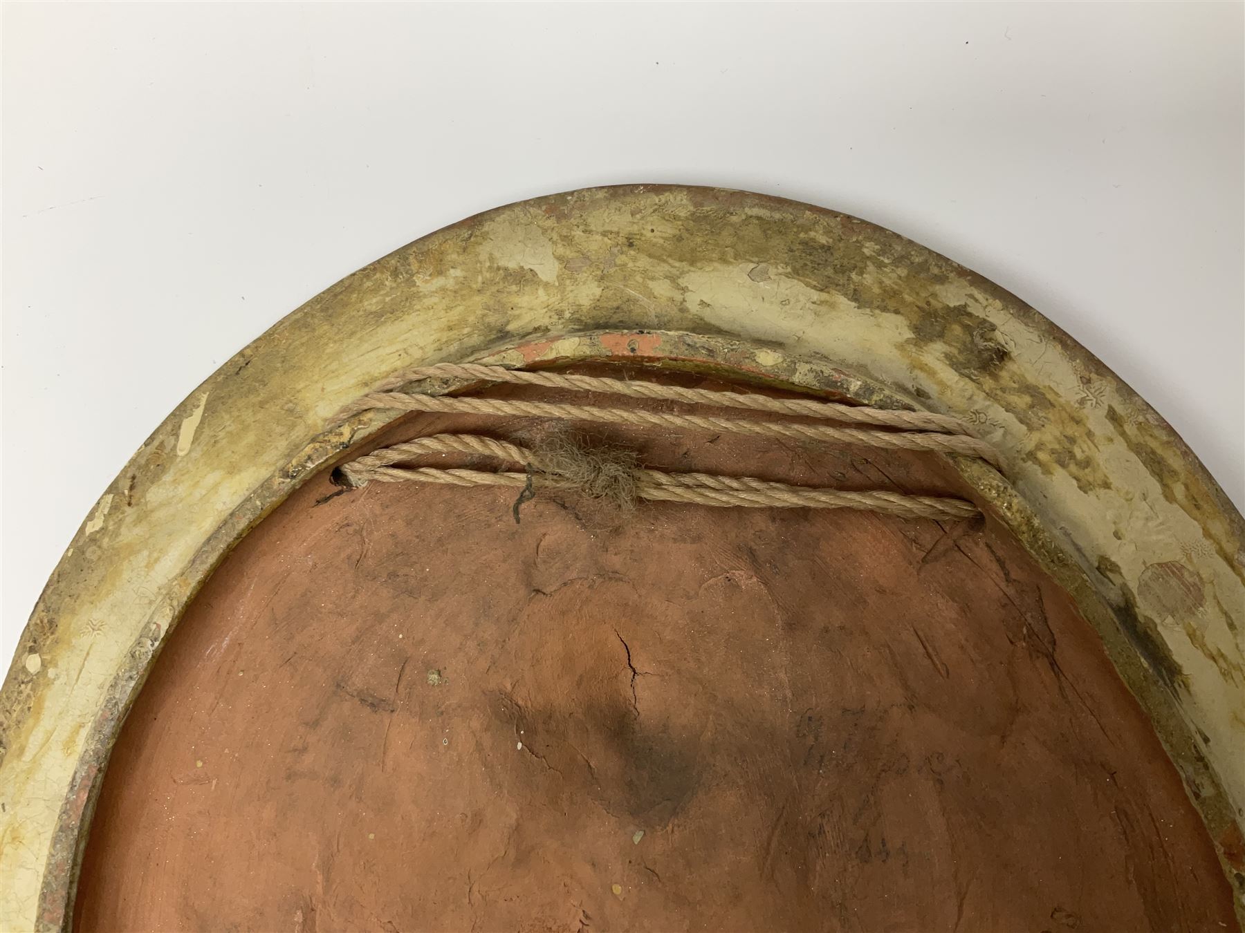 Pair of 19th century classical terracotta relief wall plaques depicting the goddess Hygeia and another goddess, seated holding an ewer, each of oval form, indistinctly signed, each stamped Ferreira verso, H42cm, W30cm