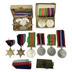 Twelve WW2 medals comprising four 1939-1945 war medals, four Defence medals, three 1939-1945 Stars and Africa Star; all with ribbons; some as groups in two issue boxes with slips