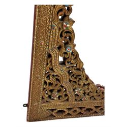 Large North African design carved and painted wall mirror, decorated with floral motifs, pierced foliate scrolls, inset mirrored panels, and colourful painted detailing, enclosing an oval bevelled mirror plate