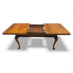 Queen Anne design walnut dining suite, comprising a rectangular dining table with carved moulded edge and rounded corners, raised on cabriole legs terminating in pad feet, together with a set of six matching dining chairs, each with shaped splat back, leather upholstered seat and cabriole supports (Extends to 230cm)