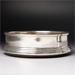 Pair of Elizabeth II silver bottle coasters with turned wooden bases D12cm, Birmingham 1994 Maker W I Broadway & Co.