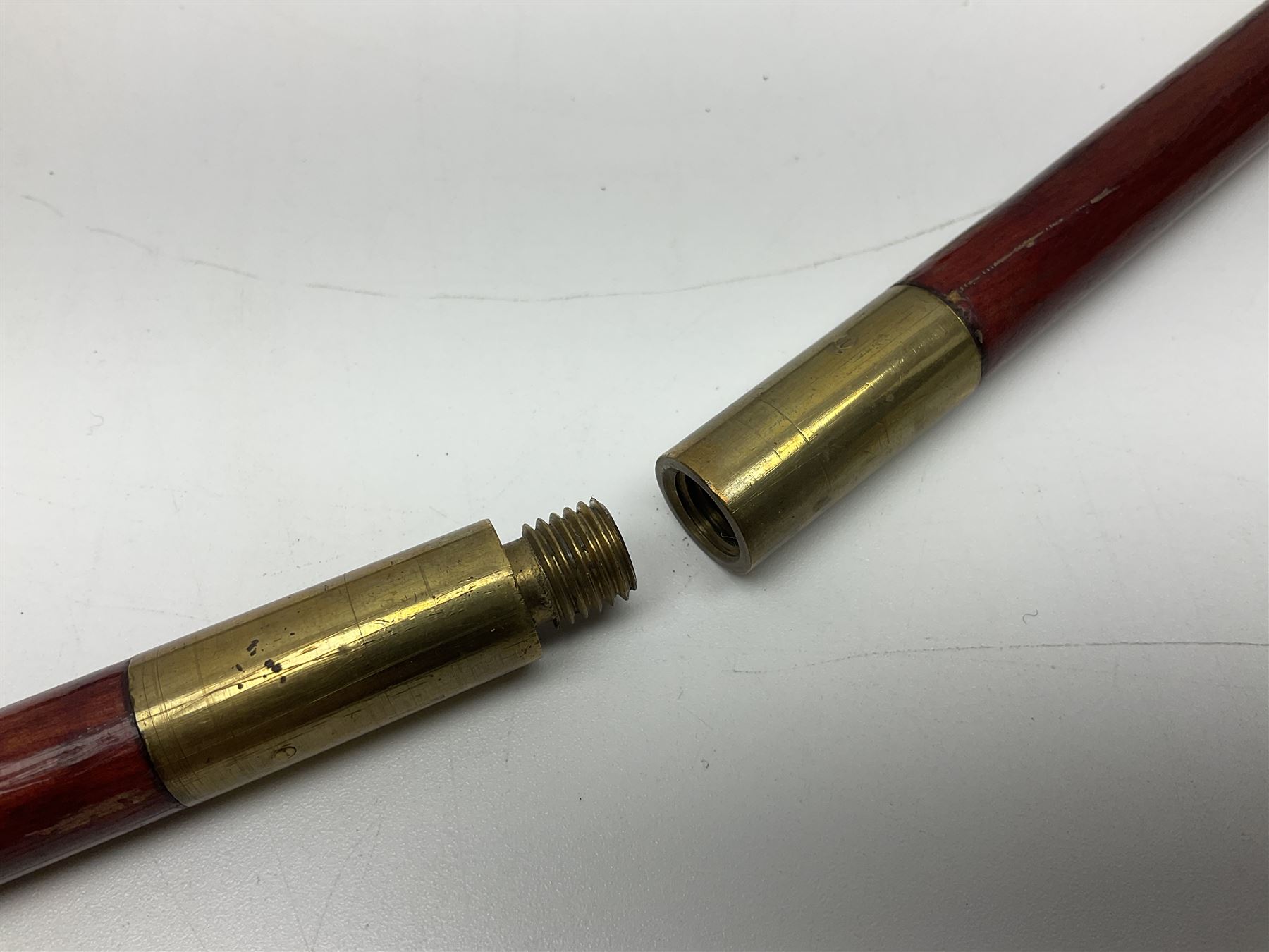 19th century continental folding knife with 15.5cm single edged blade, the pierced brass and iron handle with remains of horn grips L21.5cm overall closed; turned horn handled knife with foliate engraved blade; battlefield relic German 1884/98 knife bayonet; iron spear head; leather covered swagger stick; and two-piece gun cleaning rod