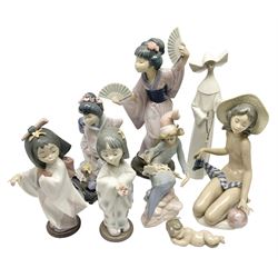 Eight Lladro figures, comprising Japanese with Fan no 4991, Michiko no 1447, Playing Flute no 6151, Bearing Flowers no 6151, Sunning no 1481, Baby Jesus no 4535, Starlight Starbright no 1476 and Serene Moment no 5550.3, largest example H28cm 
