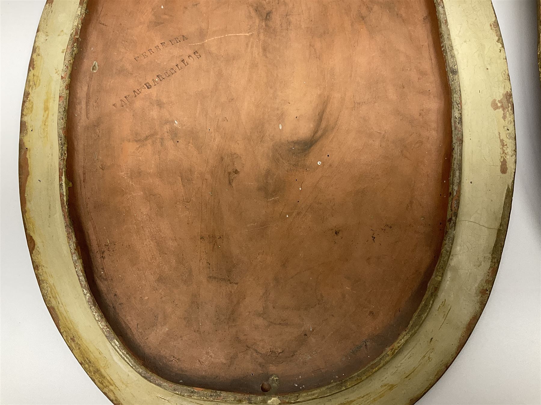 Pair of 19th century classical terracotta relief wall plaques depicting the goddess Hygeia and another goddess, seated holding an ewer, each of oval form, indistinctly signed, each stamped Ferreira verso, H42cm, W30cm