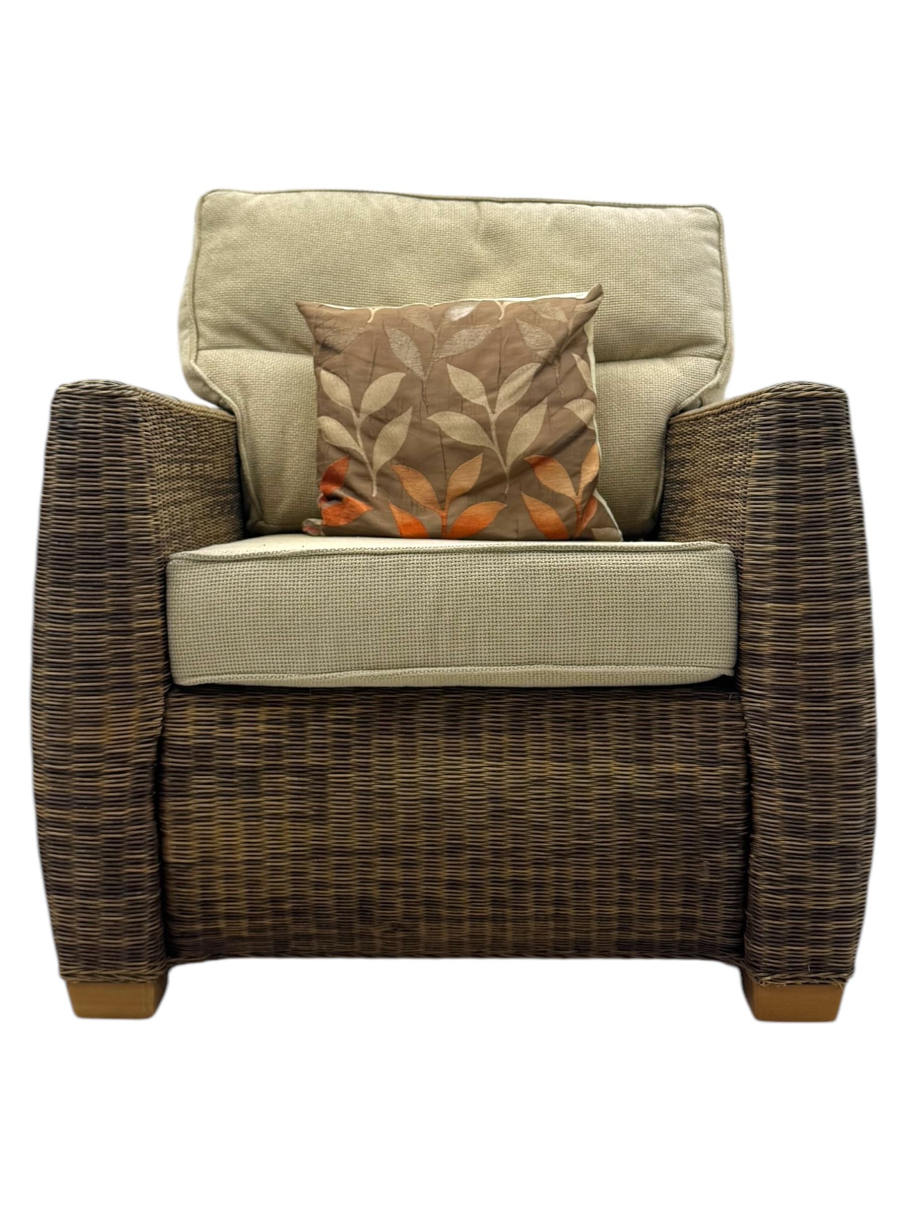 Contemporary two seat rattan conservatory sofa with loose cushions, and pair of matching armchairs, with upholstered seat and back cushions in a beige fabric, curved arms and front complete with scatter cushions 

Chairs (H 92cm, W 75cm, D 84cm)
Sofa (H 92cm, W 130cm, D 84cm)