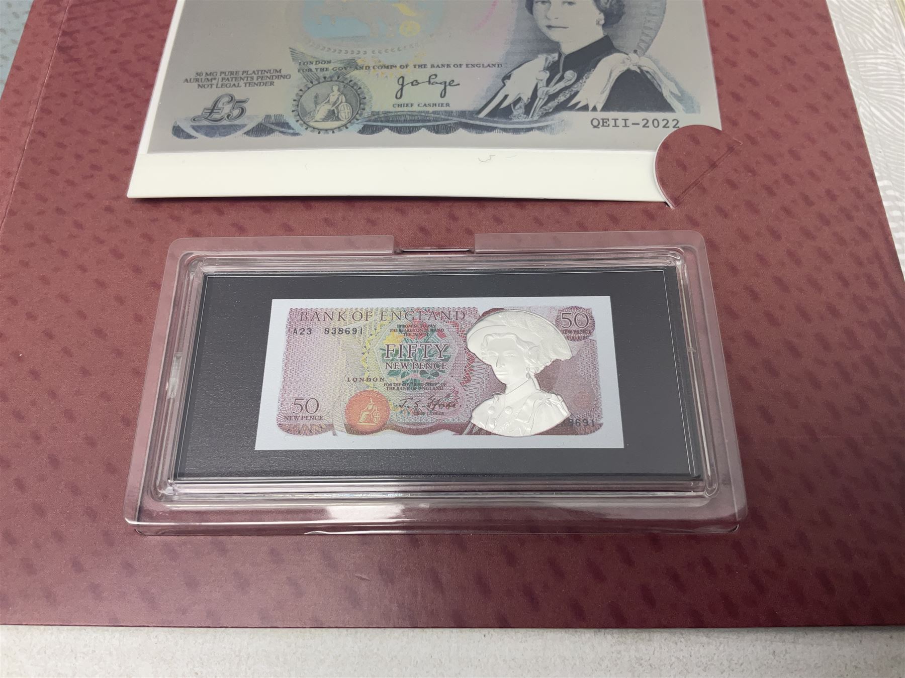 Queen Elizabeth II 'The Platinum Jubilee Banknote Collection' including 2022 'The Unissued Fifty Pence Banknote Gold Coin', housed in official card folder with certificates