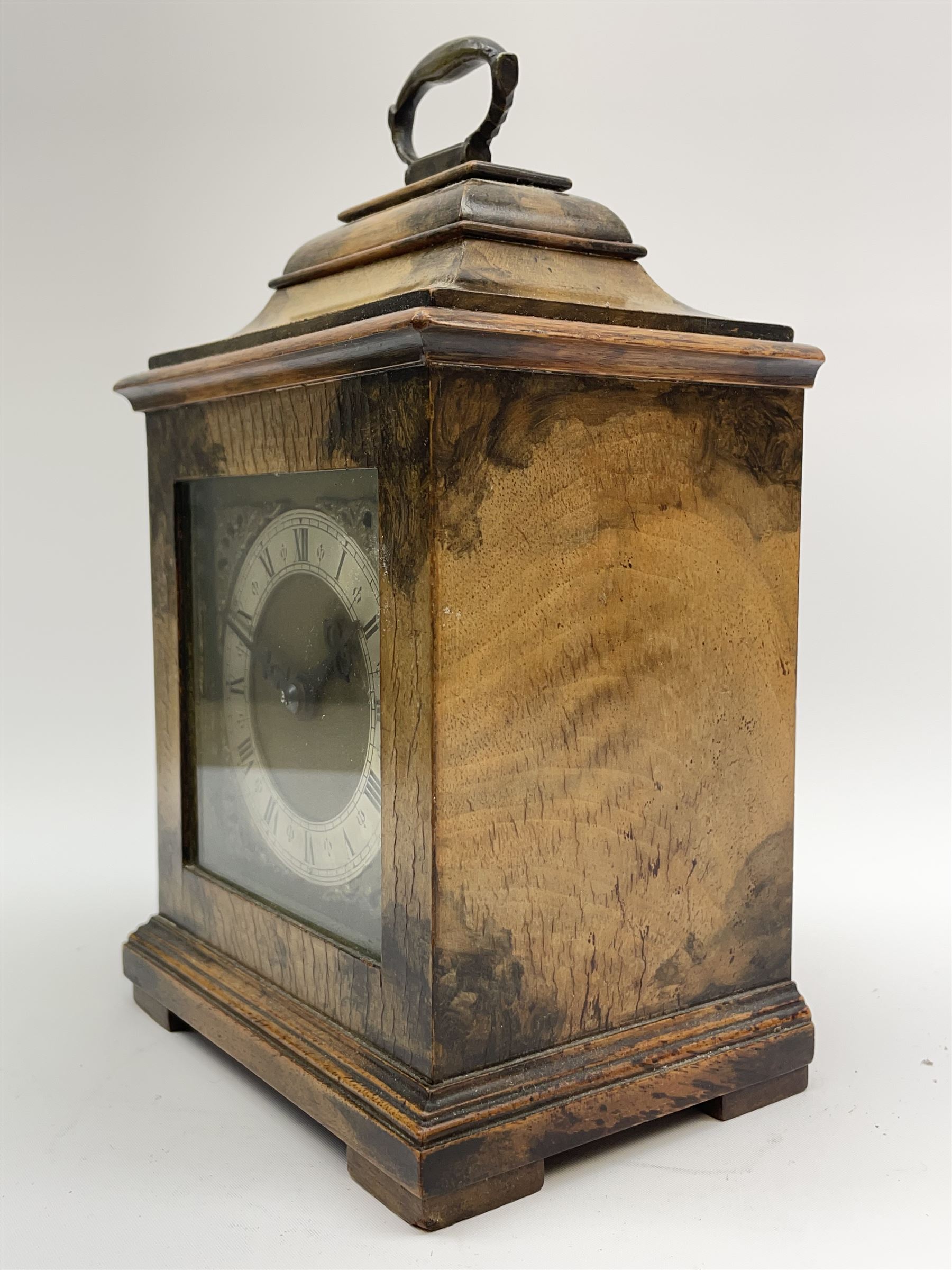 Small late 20th century walnut cased bracket clock. sarcophagus top with brass loop handle, brass dial with silvered Roman chapter ring and ornate spandrels, single train movement by 'Buren'