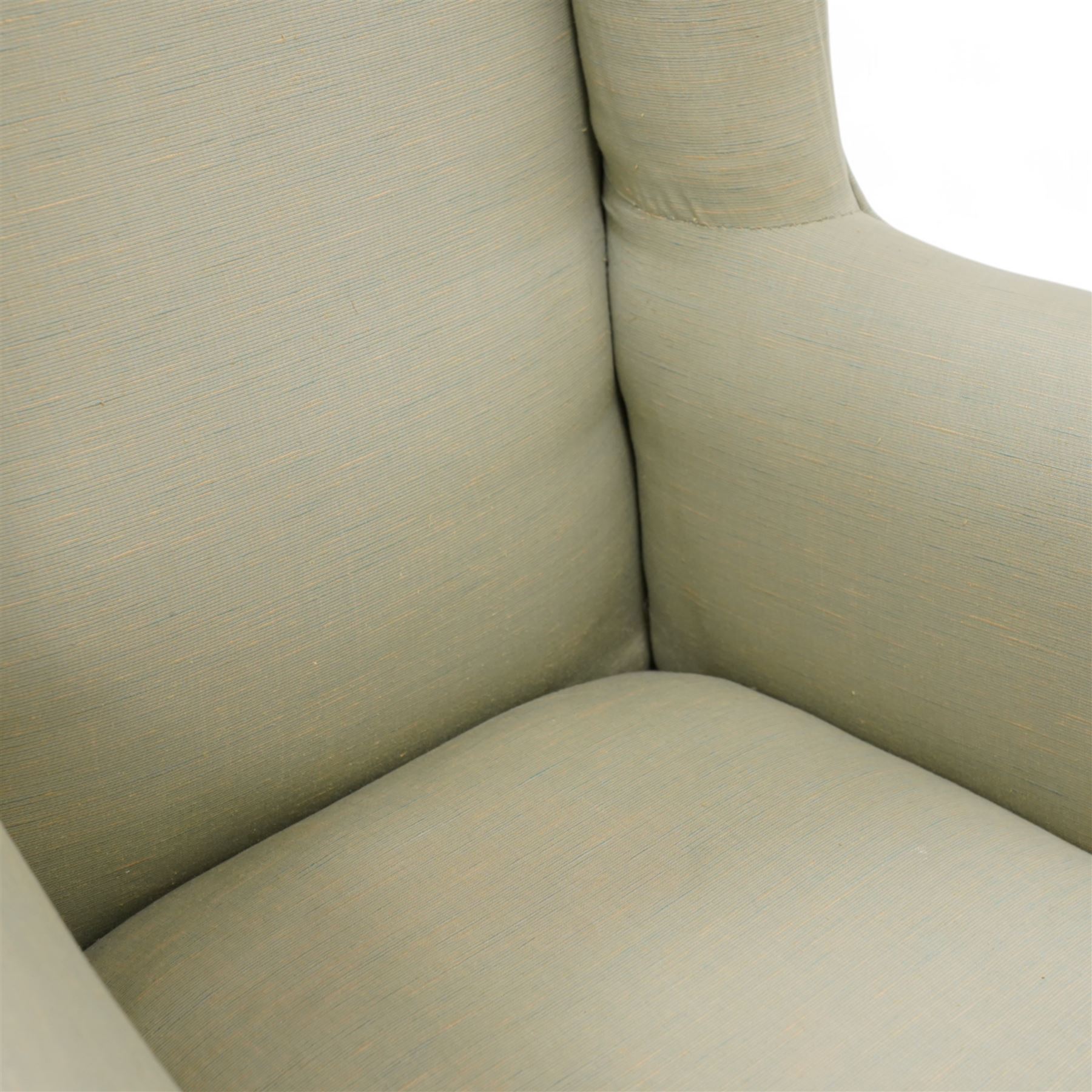 Queen Anne design hardwood framed wingback armchair, upholstered in sage green fabric, on shell carved ball and claw feet