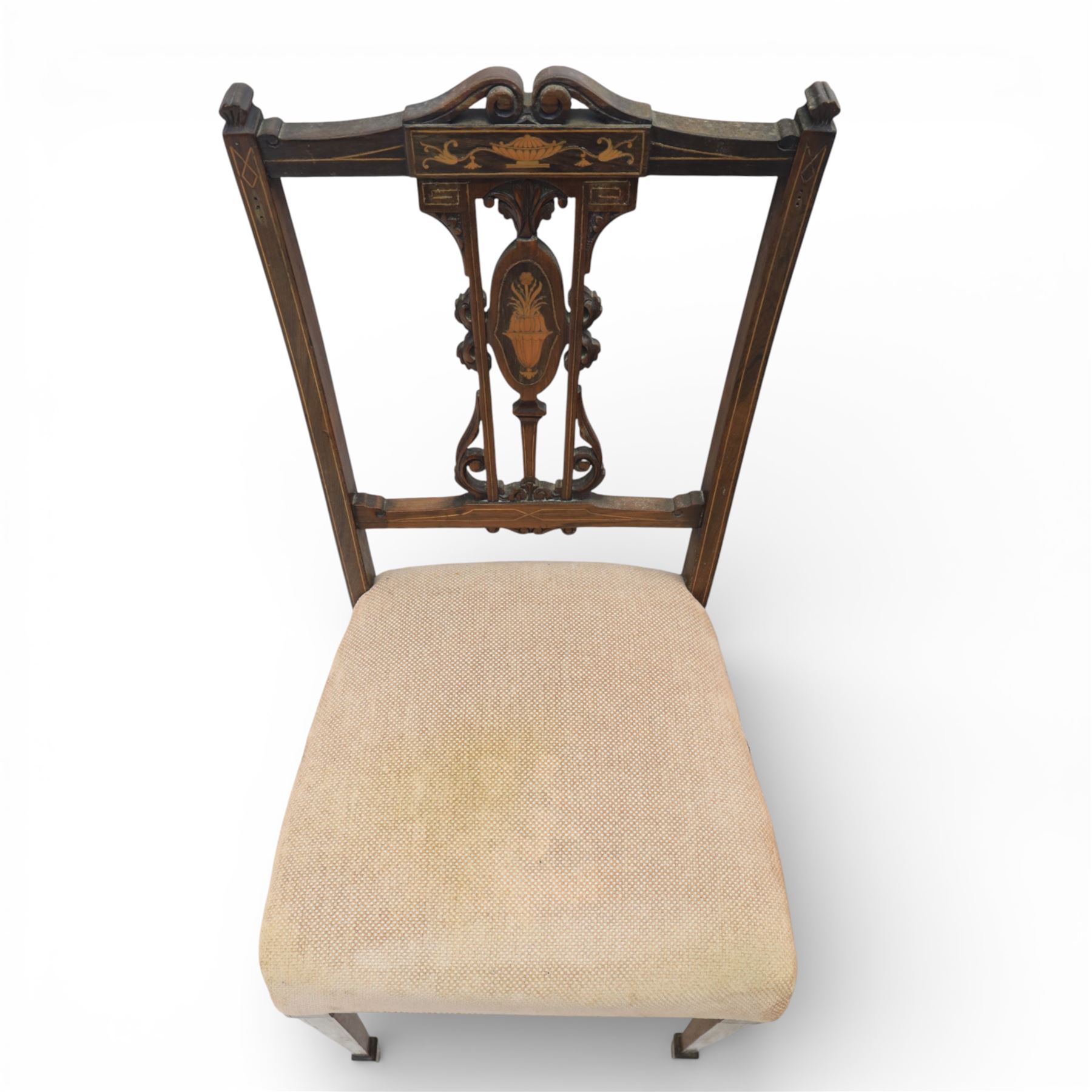 Quality Edwardian seven piece inlaid salon suite, comprising three seater settee, pair of arm chairs and four chairs with pierced splat backs, upholstered in pale pink fabric, inlaid with flowering urns, upon tapering legs with spade feet and castors