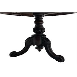 Victorian mahogany breakfast table, the circular tilt-top on carved pedestal, three moulded supports carved with bellflowers and scrolled terminals 