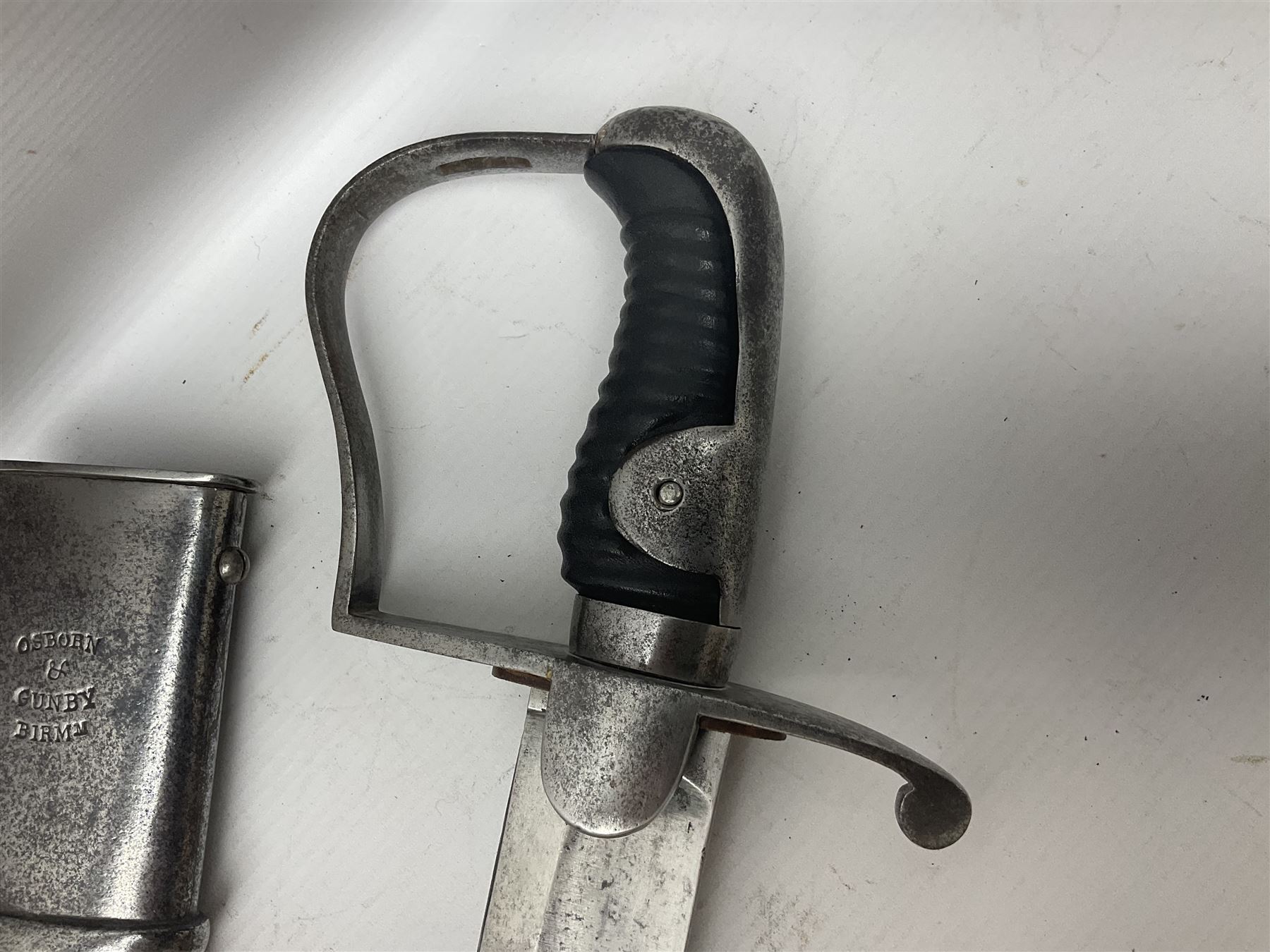 British 1796 Pattern Light Cavalry trooper's sword, the 84cm curving fullered blade stamped Hadley.1 to the back edge, steel hilt with knucklebow, D-shaped langets and leather grip; in polished steel scabbard stamped Osborn & Gunby Birmm. and W.R.16 ( ?16th Light Dragoons) with two suspension rings L100cm overall