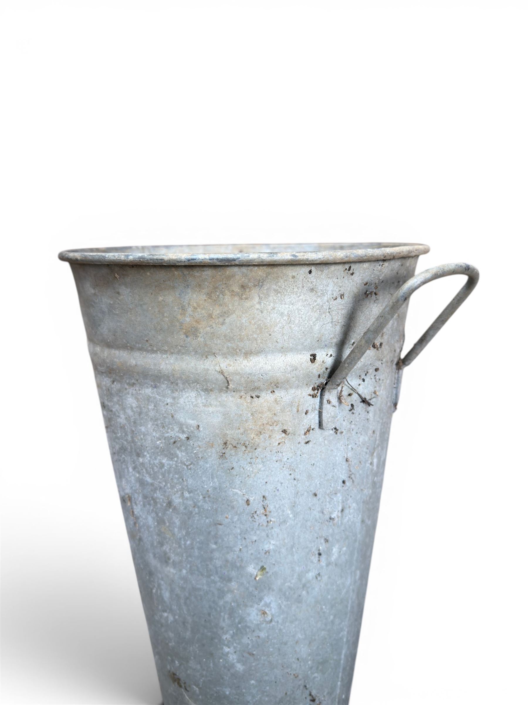 Nine galvanised flower buckets, tapering form with twin handles
