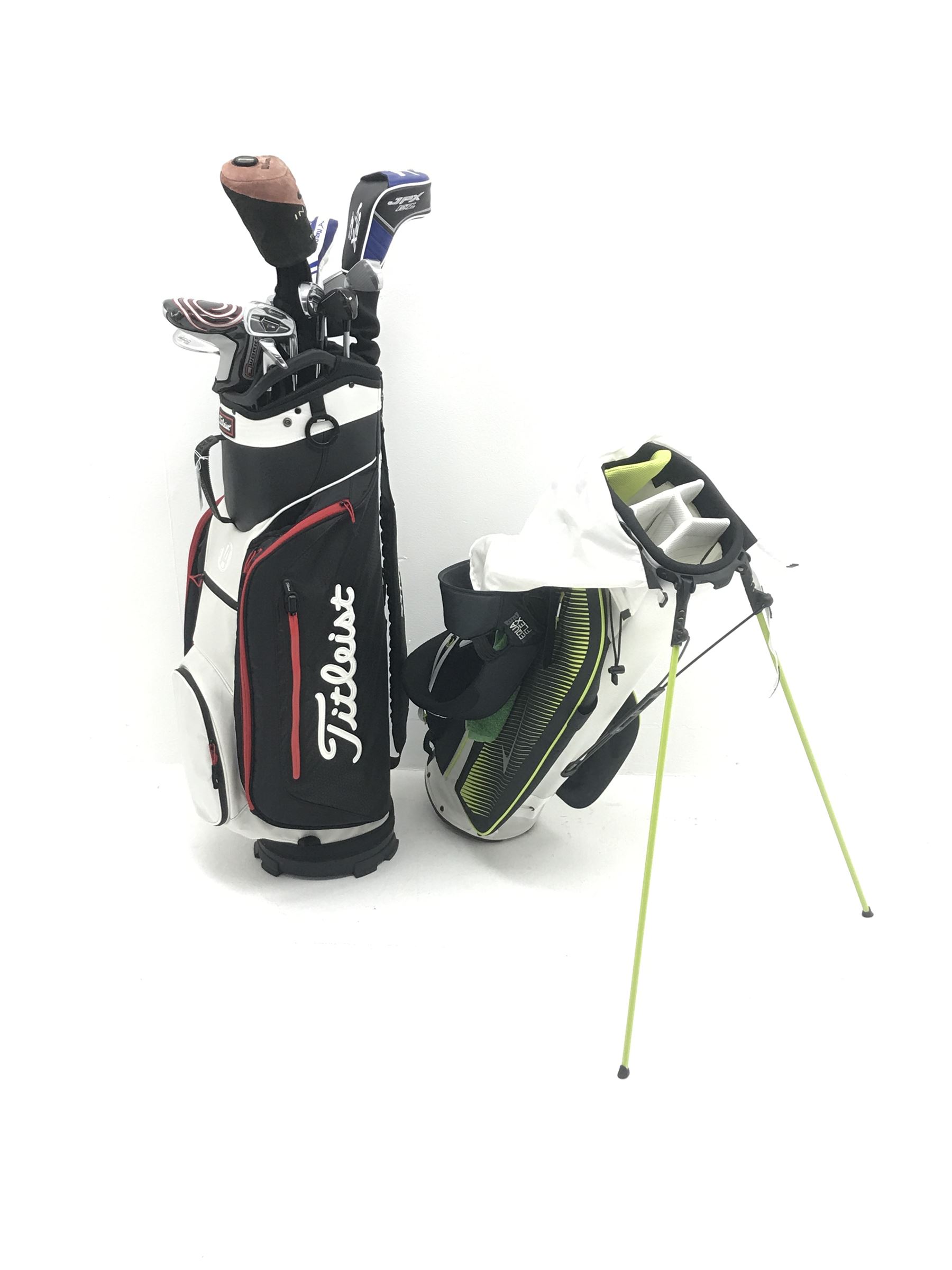 A quantity of TaylorMade golf clubs and others and two bags 