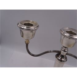 Modern silver mounted three branch candelabra, the tapering stem supporting a central candle holder and two curved branches with candle holders, upon weighted stepped circular foot, hallmarked A T Cannon Ltd, Birmingham 1973, H22.5cm