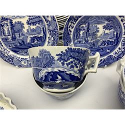Spode blue and white Italian pattern dinner and tea wares, comprising five dinner plates, four side plates, seventeen side plates, four bowls, ten tea cups and twenty one saucers, five coffee cans and six saucers, and a flan dish, with blue and black printed marks beneath 