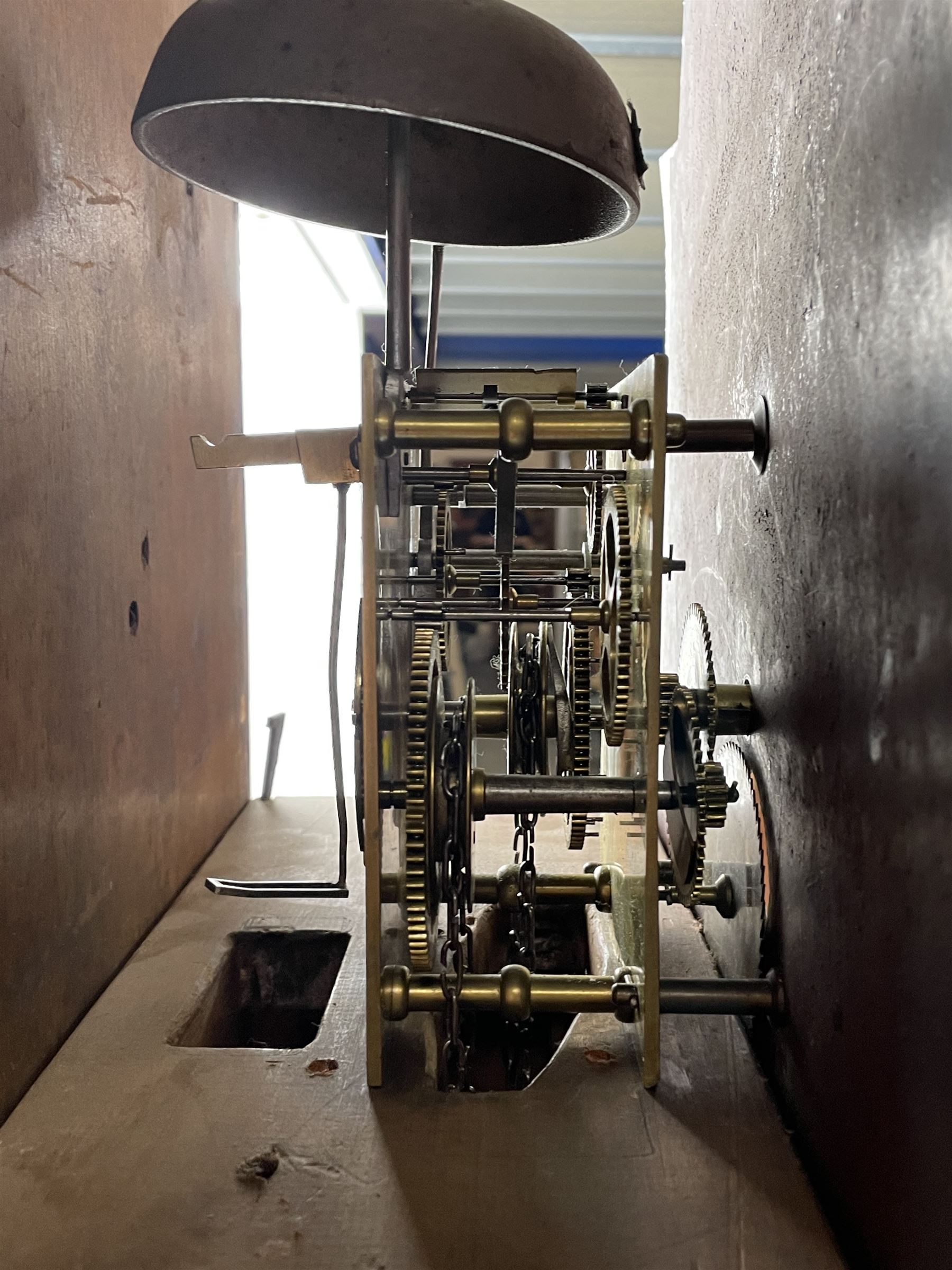 Early 19th century oak and rosewood banded longcase clock, scrolled pediment over stepped arch hood door, enamel painted dial indistinctly signed for a Penrith maker, 30-hour movement striking on bell