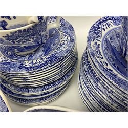 Spode blue and white Italian pattern dinner and tea wares, comprising five dinner plates, four side plates, seventeen side plates, four bowls, ten tea cups and twenty one saucers, five coffee cans and six saucers, and a flan dish, with blue and black printed marks beneath 