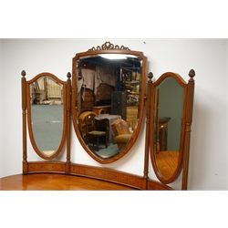  Edwardian Sheraton Revival satinwood kidney shaped dressing table, with three mirrors on fluted supports with pineapple finials, the one long and four short drawers with brass ring handles on fluted tapering supports with brass sockets and castors joined by curved stretchers, H160cm, W142cm, D70cm  