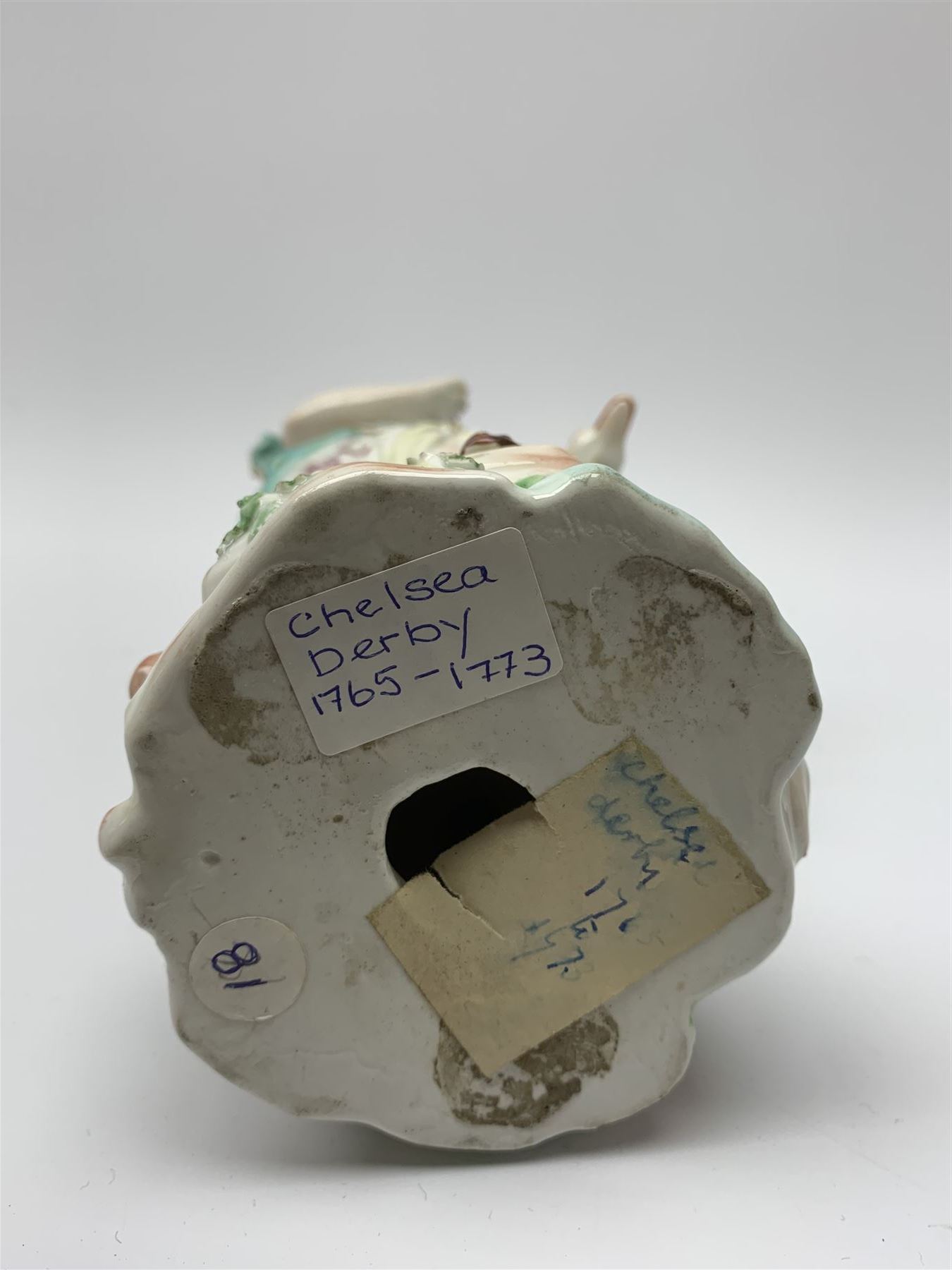 Mid 18th century Derby porcelain figure modelled as Dianna the Huntress, with quiver of arrows upon her back and dog by her side, upon a naturalistically modelled base, with patch marks beneath and collectors labels, H26cm